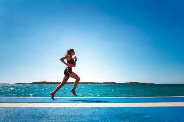 Woman running showing strong leg muscle Wilmslow